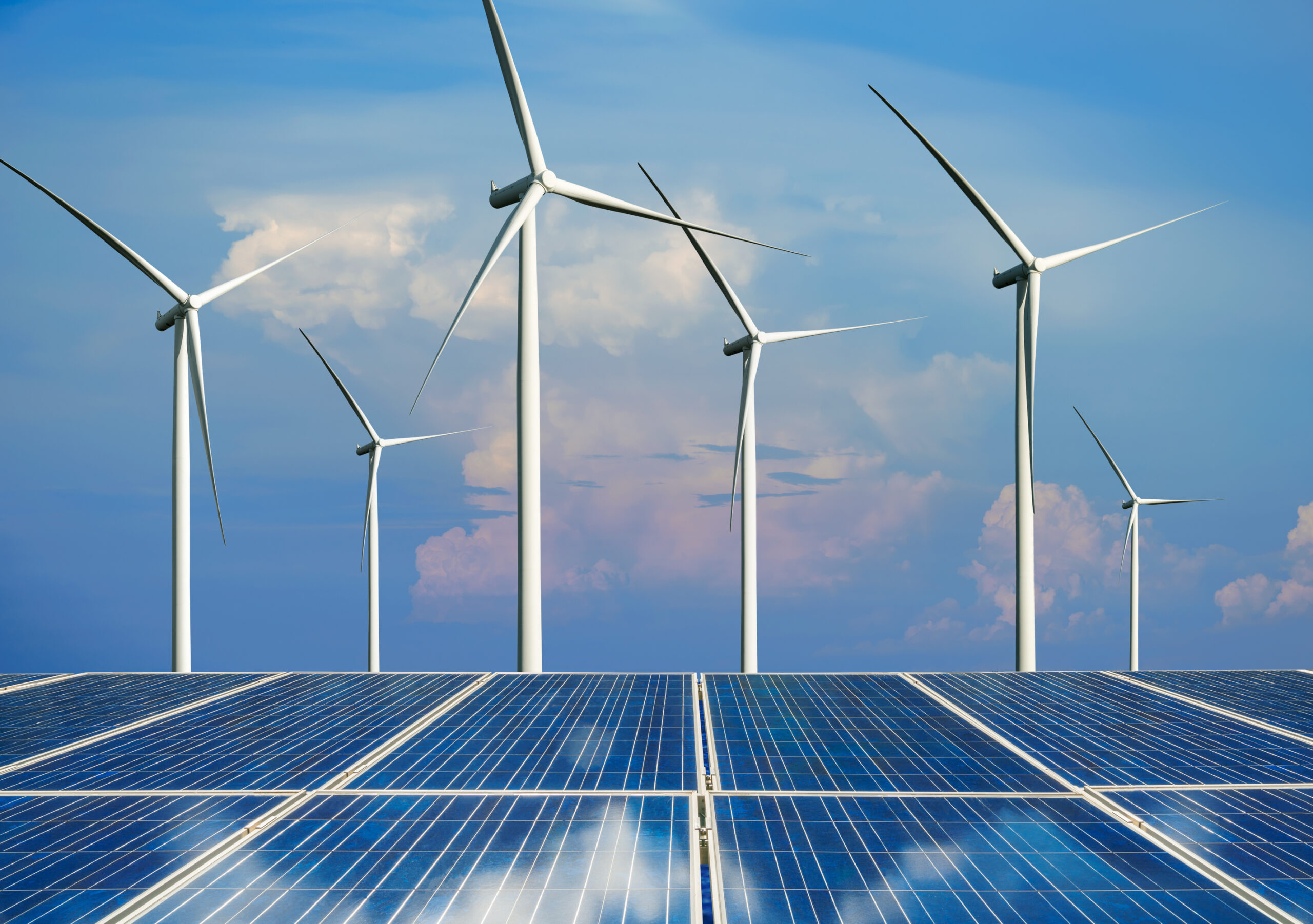 Solar energy panel photovoltaic cell and wind turbine farm power generator in nature landscape.